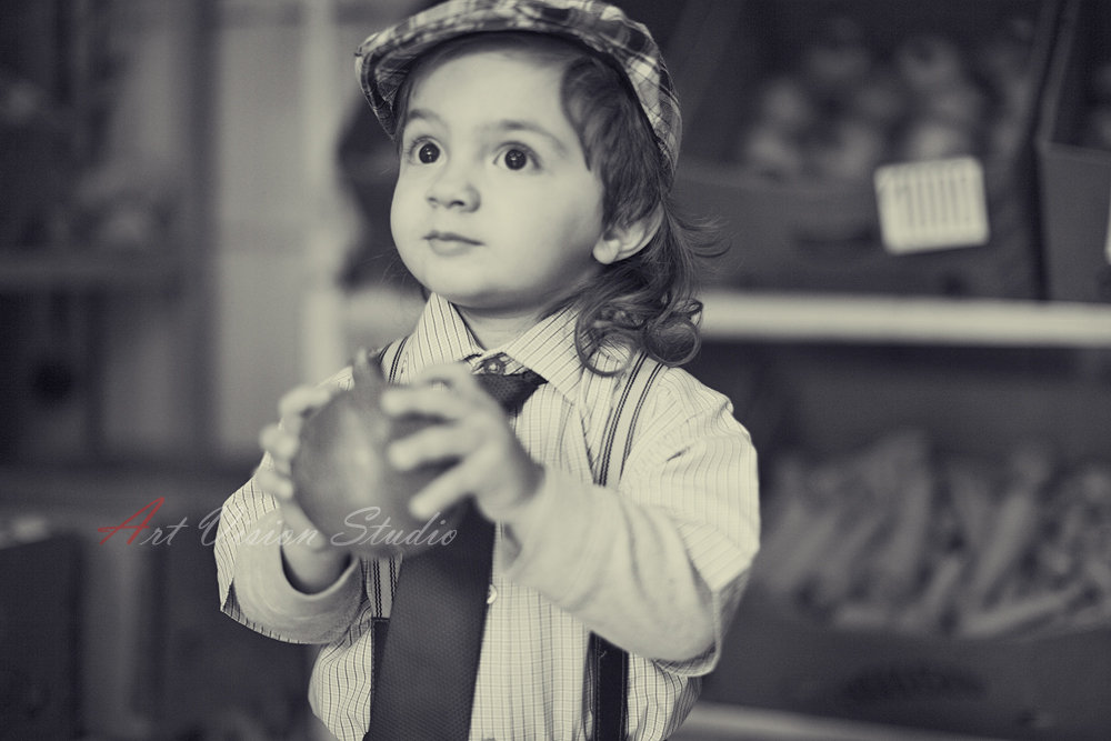 Stamford, CT child photographer - Black and white portrait of a boy with a pomegranate