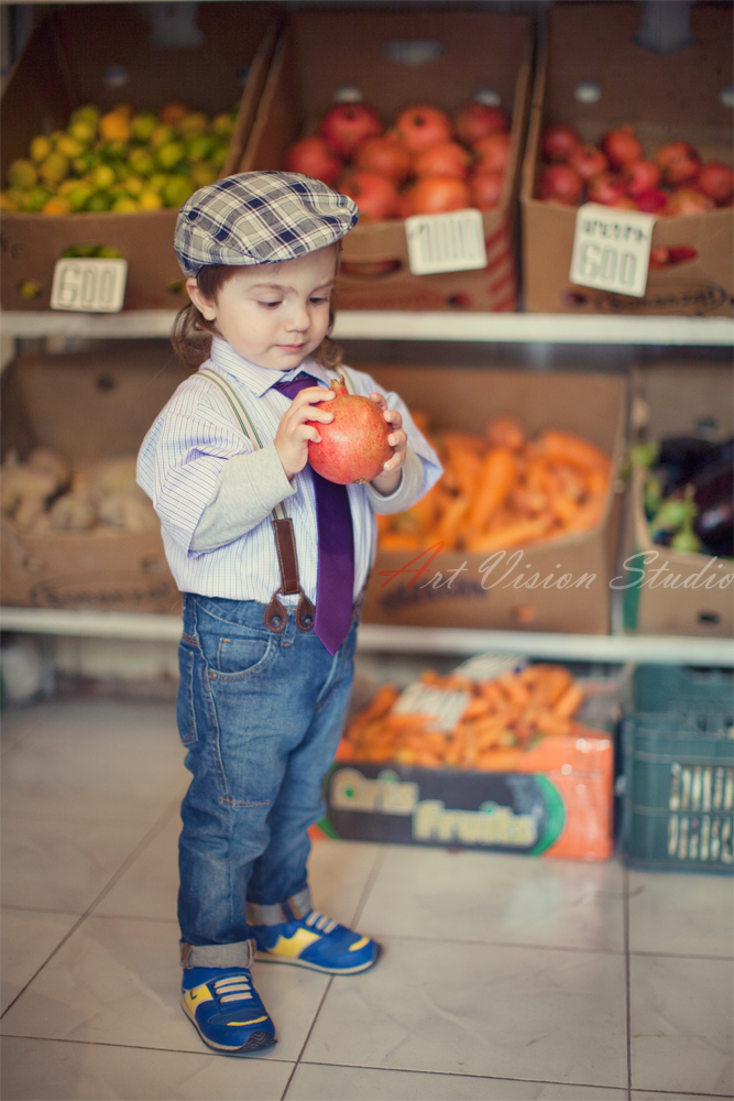 Stamford CT children photography - Toddler posing with a pomegranate for pictures