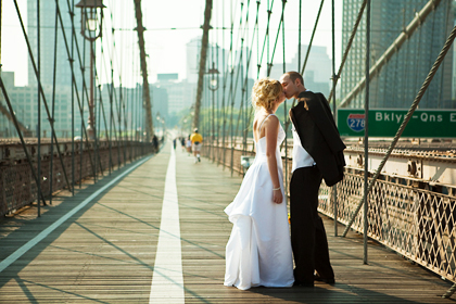 A wedding couple posing on a bridge