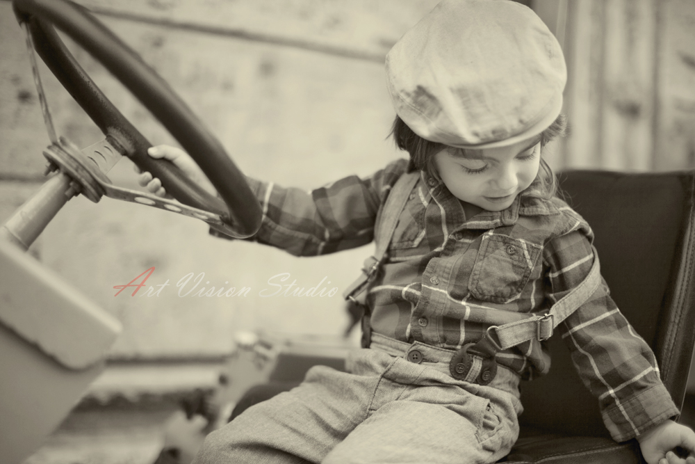 Stamford, CT lifestyle toddler photographer - Black and white image of a boy at the wheel of a contstruction truck, CT