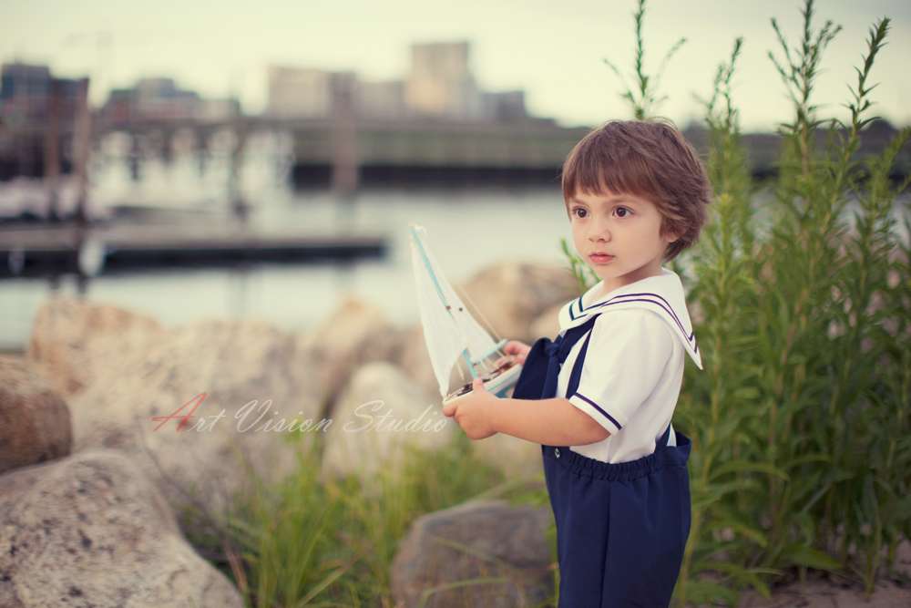 Darien, CT kids portrait photographer - Toddler boy dressed in a vintage sailor fashion posing with a sail boat toy 