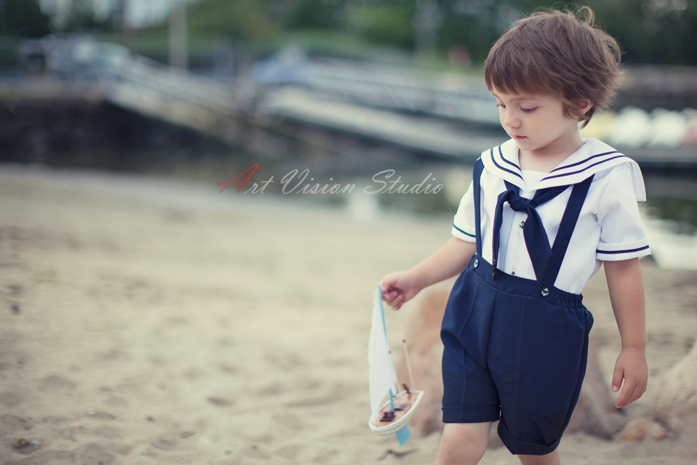 Sailor styled toddler photography sessions in Stamford, CT - Toddler boy dressed as a sailor with a toy boat